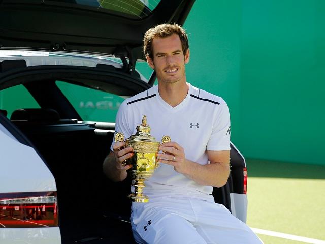 Andy Murray shows off his Wimbledon trophy